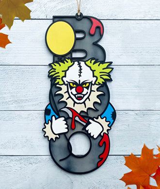 BOO wooden door sign featuring the letters B O O in a vertical format with various Halloween images pictured on top of the BOO. This one features a scary clown holding a yellow balloon. 