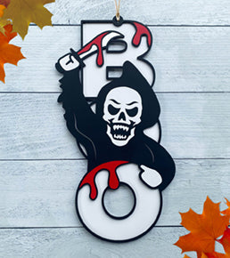 BOO wooden door sign featuring the letters B O O in a vertical format with various Halloween images pictured on top of the BOO. This one features a Grim Reaper lunging out. 