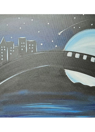 Canvas painting of a bridge at night with a large moon behind the bridge on the right side and a cityscape just over the bridge on the left side. There are many stars in the sky, including one shooting star which is accented with a glued-on rhinestone. 